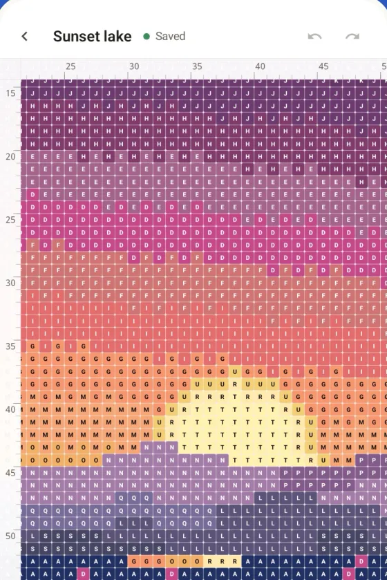 A diamond painting of a sunset over a lake on an Android phone, each drill with its symbol